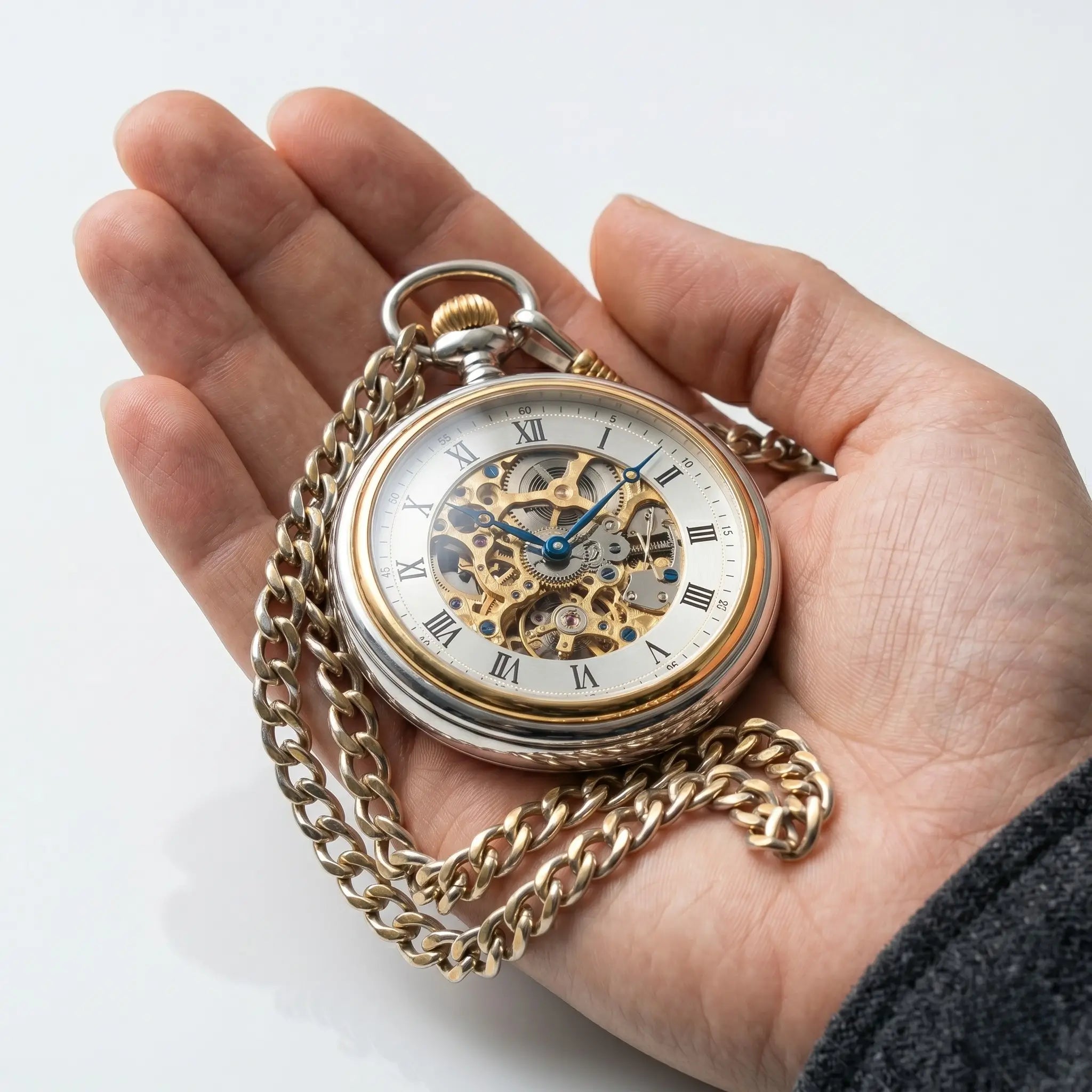 Best-selling mechanical pocket watch held in a hand against a clean light grey background. Image
