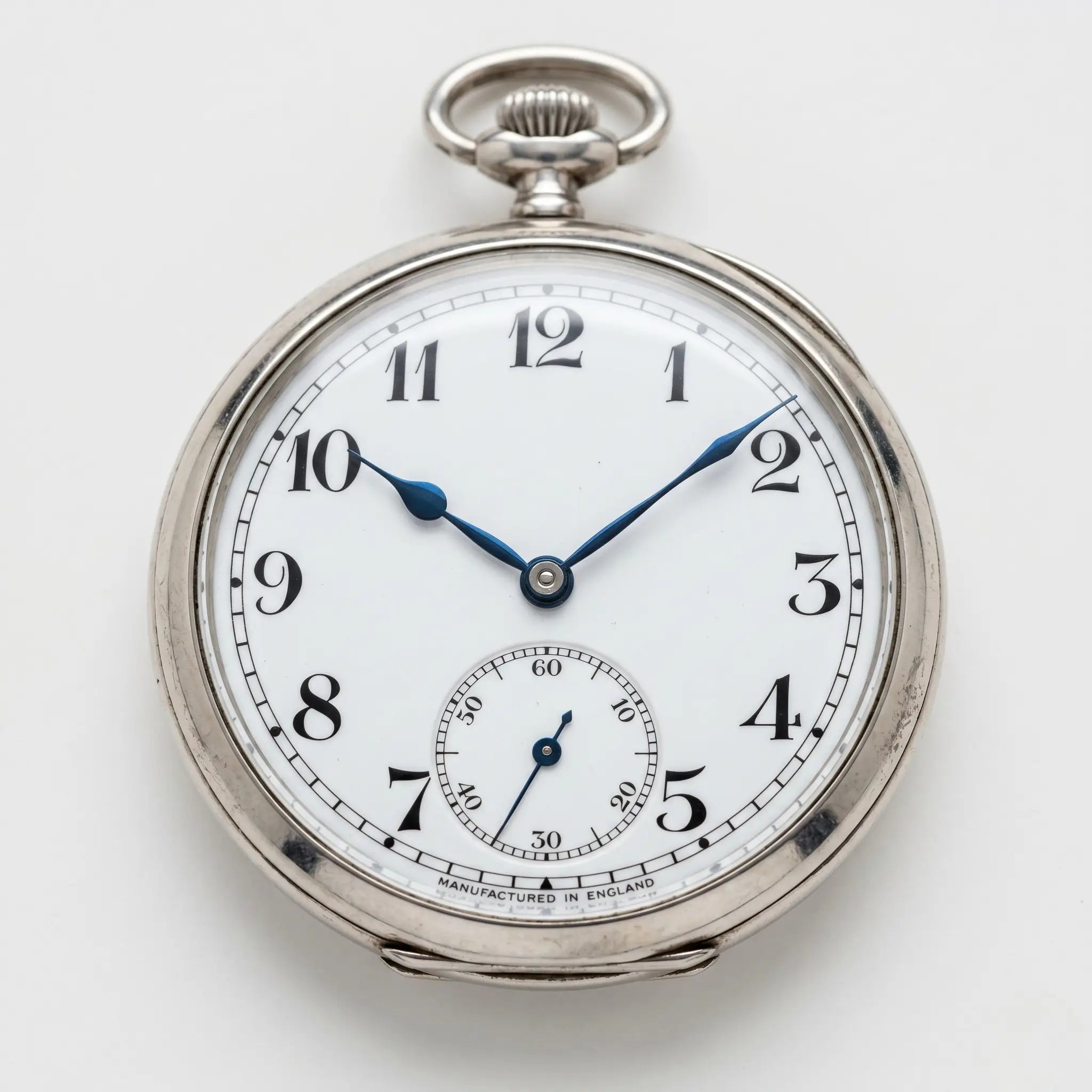 Classic silver open face pocket watch showing Arabic numerals and blue hands Image