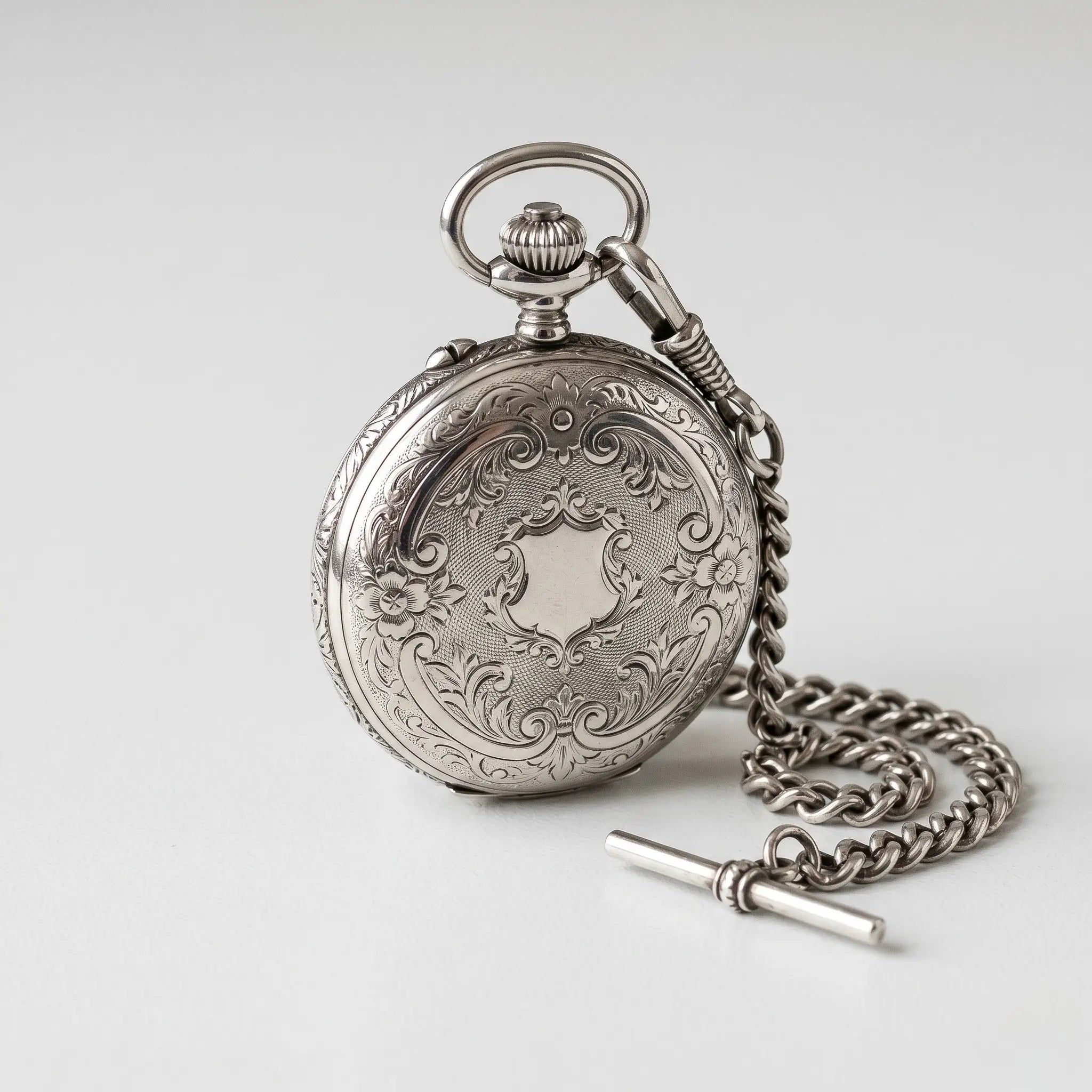 Crisp sterling silver pocket watch showcasing a highly reflective metallic finish Image