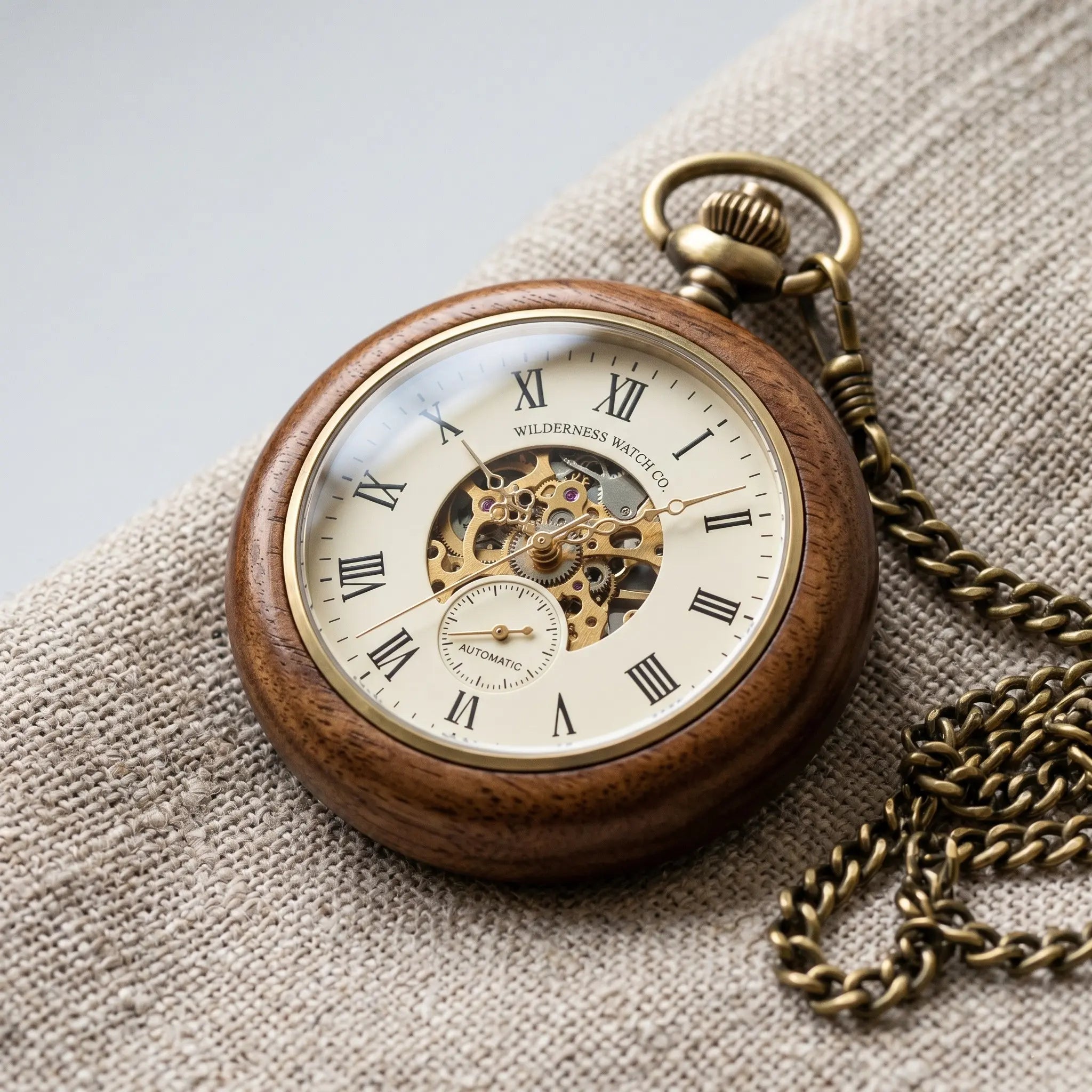 Unique wooden pocket watch with a polished walnut casing displaying wood grain. Image