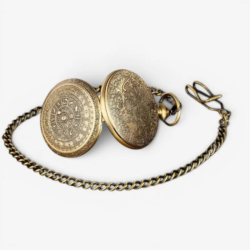 Antique brass 1920s mens pocket watch with intricate engraved zodiac and floral designs attached to a matching chain