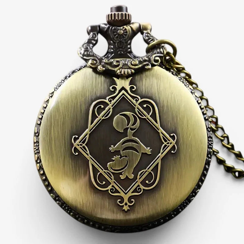 Antique brass-colored alice in wonderland pocket watch with ornate filigree and stylized character engraving