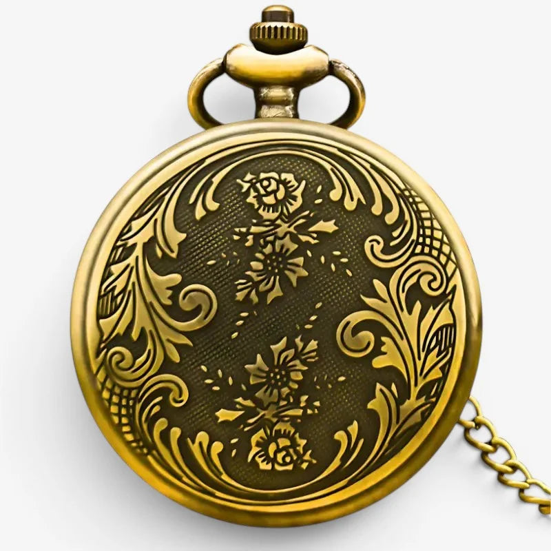 Antique bronze pocket watch with antique gold-toned intricate floral and scrollwork engraving on its darkened face