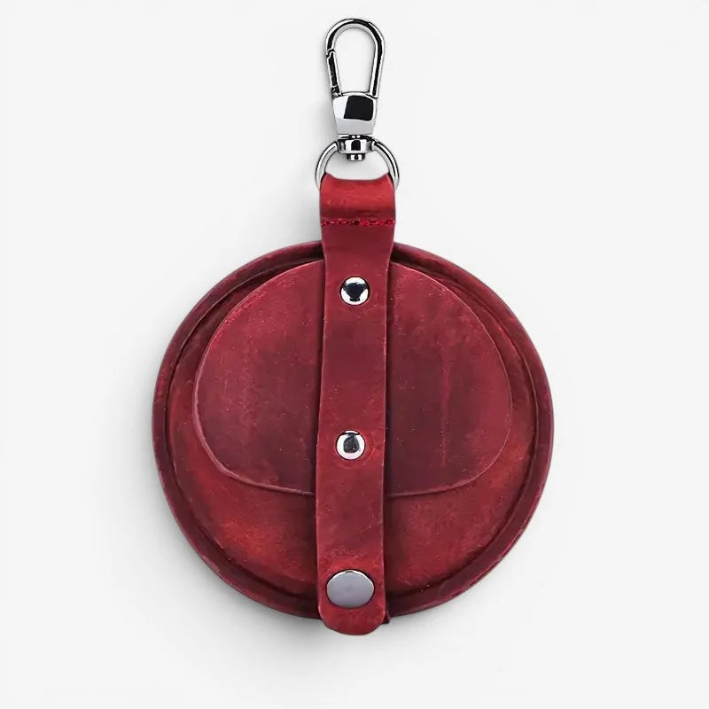 Red circular leather keychain with silver metal hardware and snap buttons for antique pocket watch case