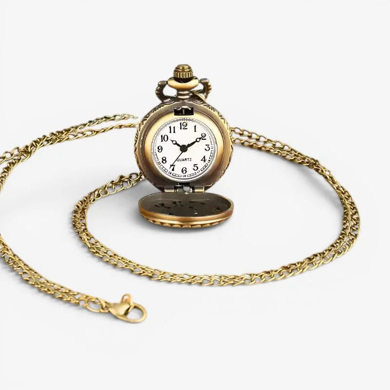Antique pocket watch necklace with gold-toned metal, white face, black numerals, and ornate chain suspension