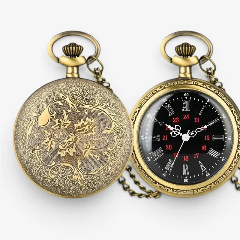 Antique roman numeral pocket watch showing ornate floral engraving on the brass back and black face with red numerals