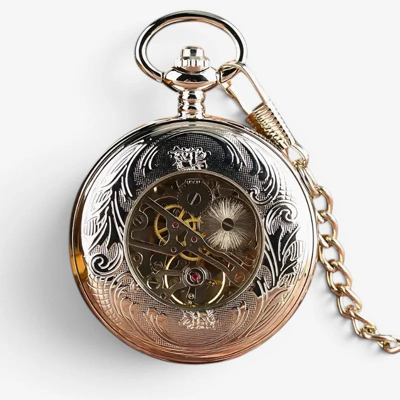 Antique silver pocket watch with gold-toned intricate floral engravings and visible mechanical movement