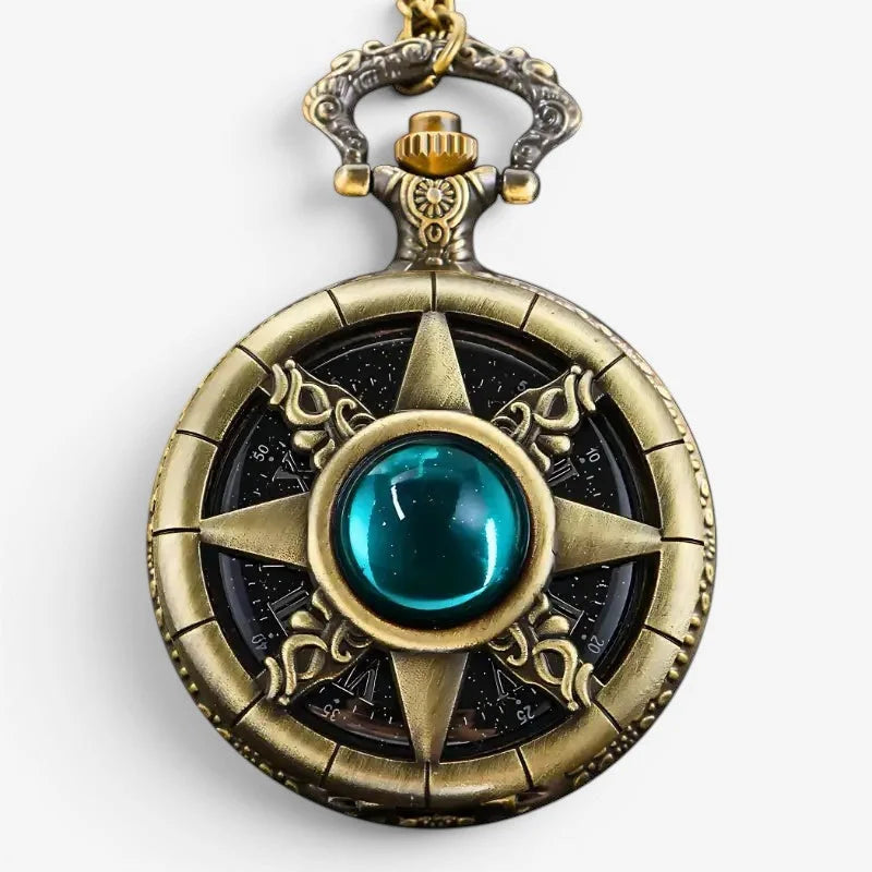 Antique stone pocket watch in brass color with ornate star-shaped compass design and central teal gemstone