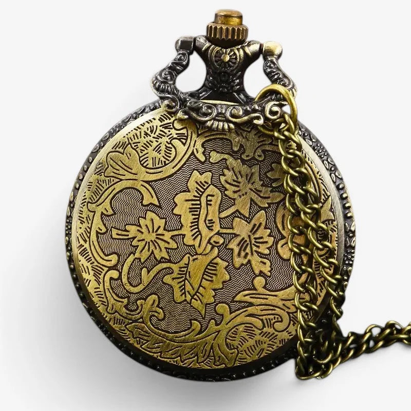 Antique stone pocket watch with intricate floral engravings in brass and a decorative chain