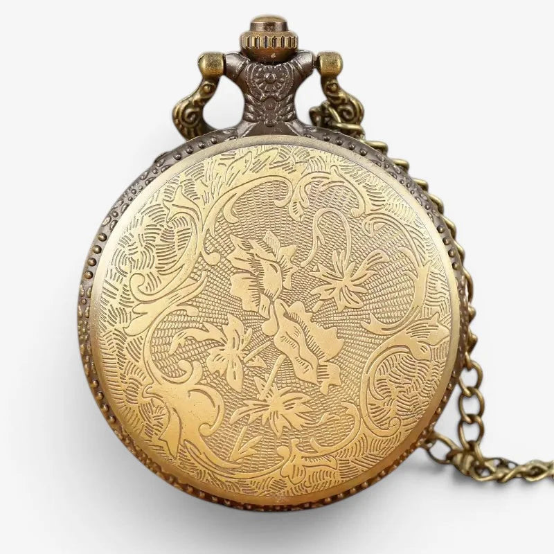 Antique gold-toned astrology pocket watch with intricate floral engravings and decorative chain in metal finish