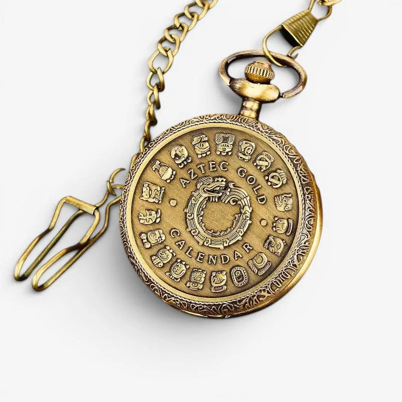 Antique brass-colored aztec pocket watch with ornate detailing and aztec calendar design on the front cover