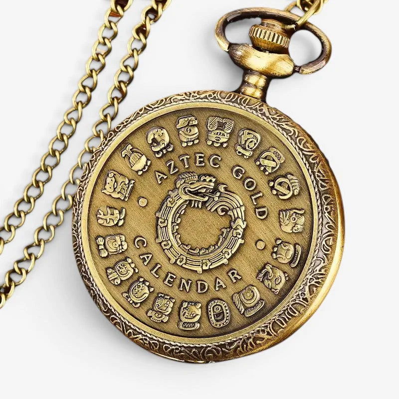 Antique brass-colored aztec pocket watch with intricate aztec calendar design and ornate detailing