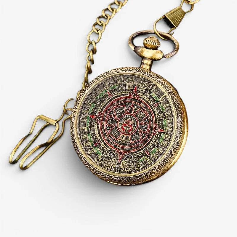 Antique brass Aztec pocket watch with intricate red green and gold Aztec calendar design on its face