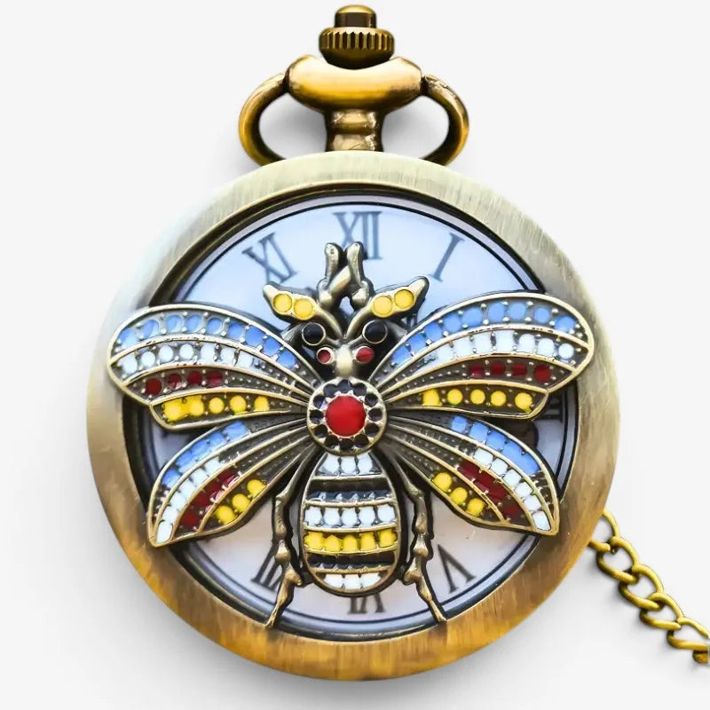 A vintage-style brass bee pocket watch with colorful red yellow and blue jeweled enamel wings design