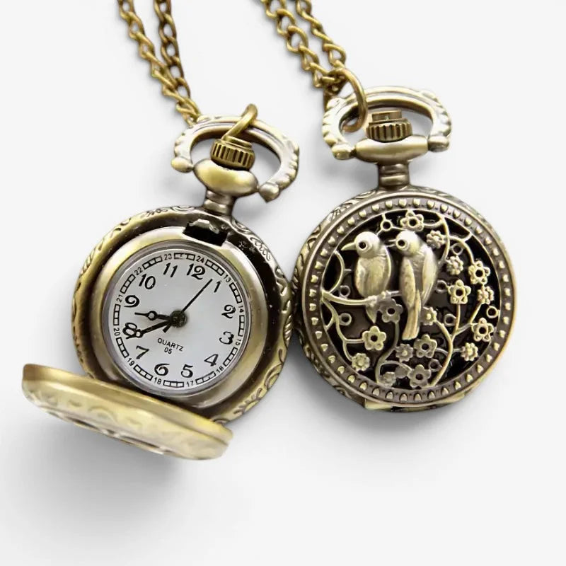 Antique brass-colored bird necklace pocket watch back with intricate floral filigree design and white dial with black numerals