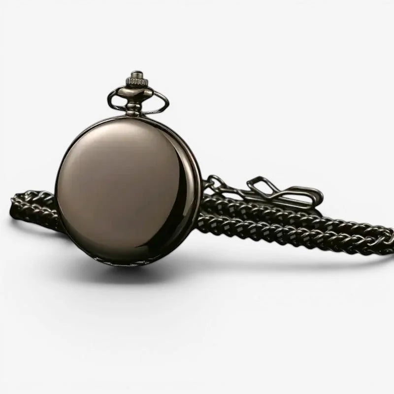 A sleek dark bronze finished black mechanical pocket watch with polished circular face and braided metal chain