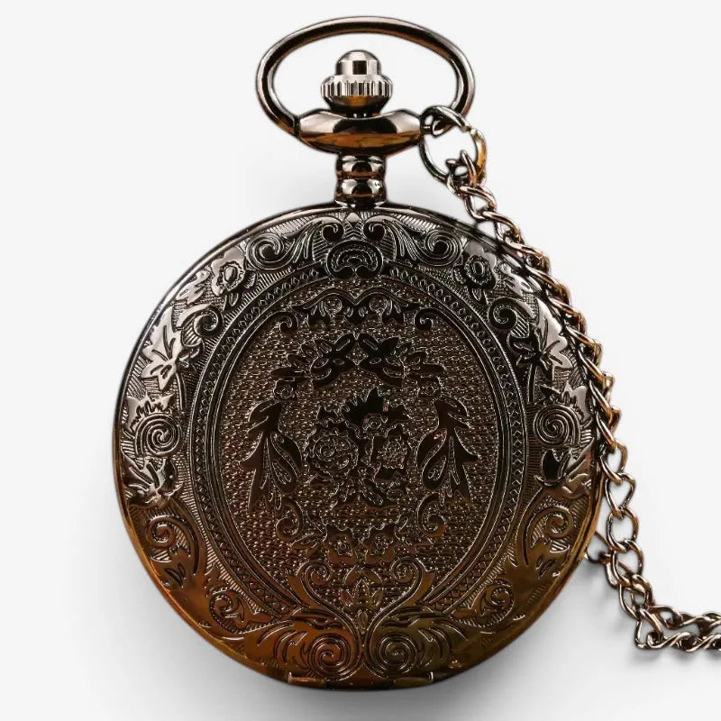 Black quartz pocket watch antique bronze color with intricate floral engraving and decorative crown on circular face