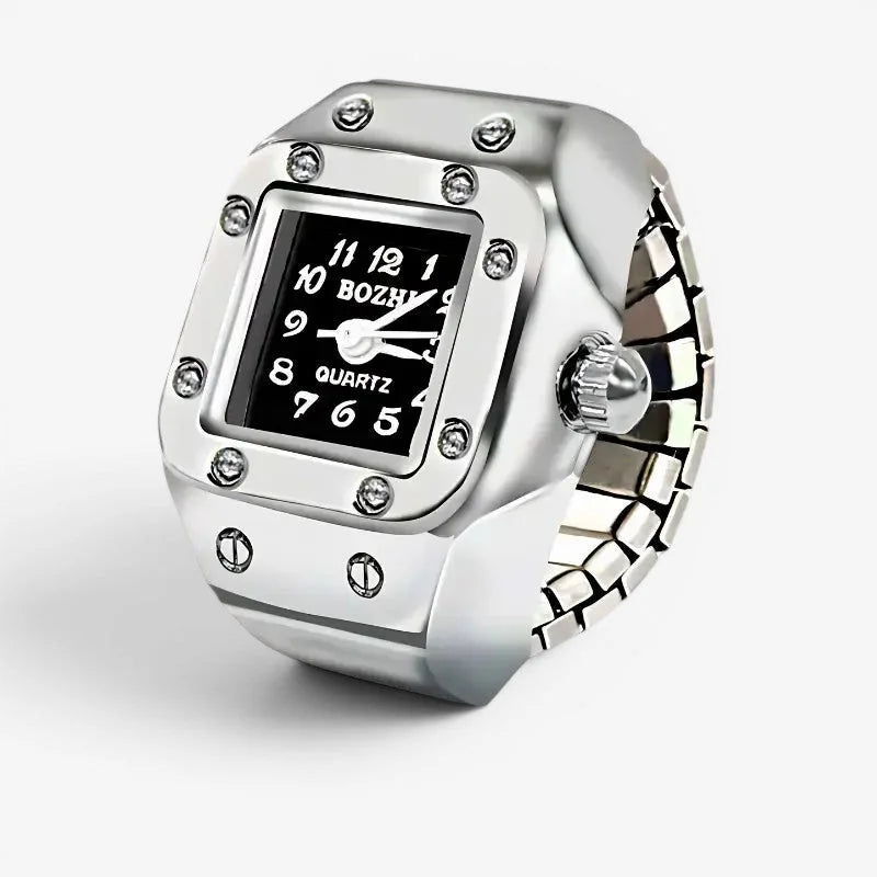 Black quartz ring watch with silver-toned rectangular frame, black face, white numerals, and clear stone accents