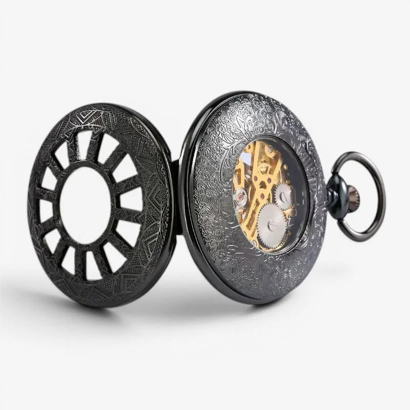 Black vintage pocket watch steampunk with intricate engraved black case and visible golden mechanical movement