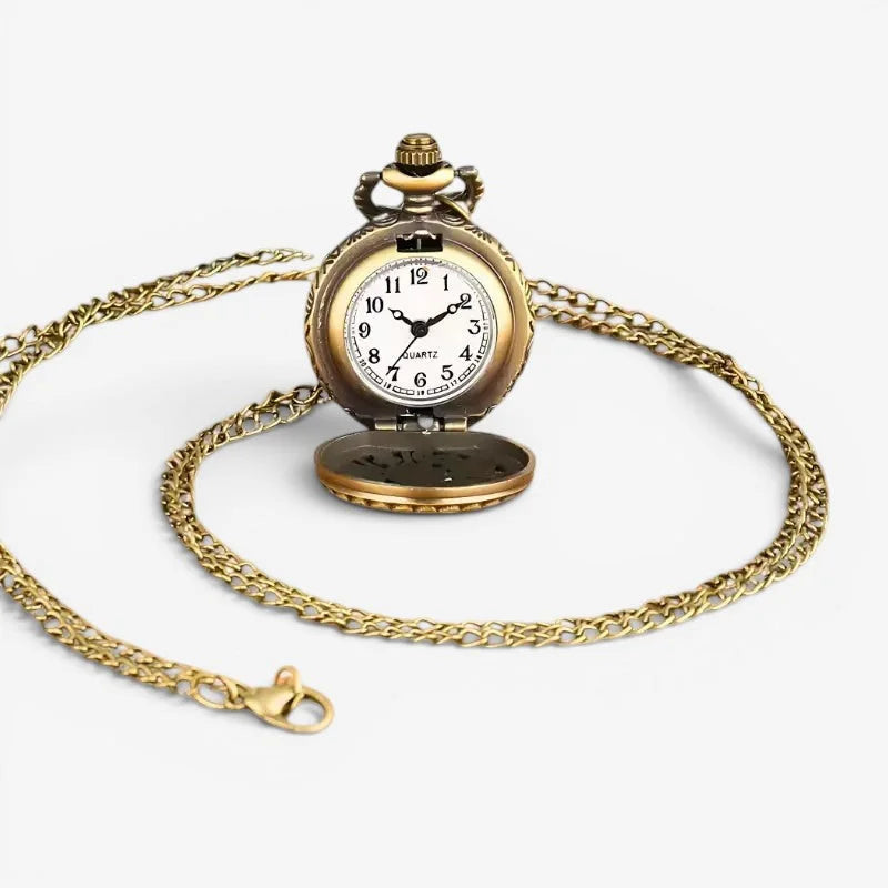 Antique gold-toned Blue Owl pocket watch with white face black numerals on an ornate chain