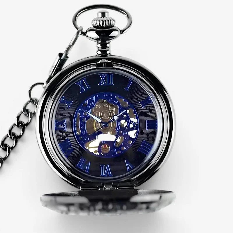 A sleek black pocket watch with a blue skeletonized face and exposed brass gears featuring roman numerals