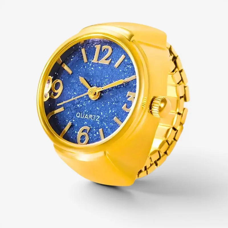 Blue quartz ring watch with a gold-toned band and sparkling blue dial featuring gold numerals