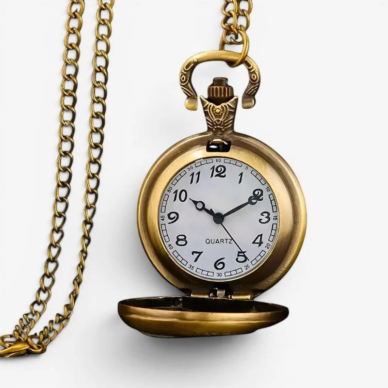 Antique gold-toned boho pocket watch with white face black arabic numerals and hands hanging from ornate chain