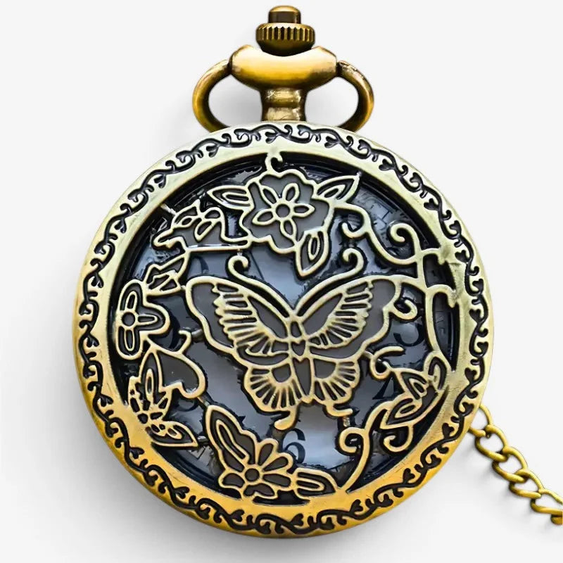 Antique bronze butterfly pocket watch with intricate brass engraving and dark blue glass face on an ornate chain