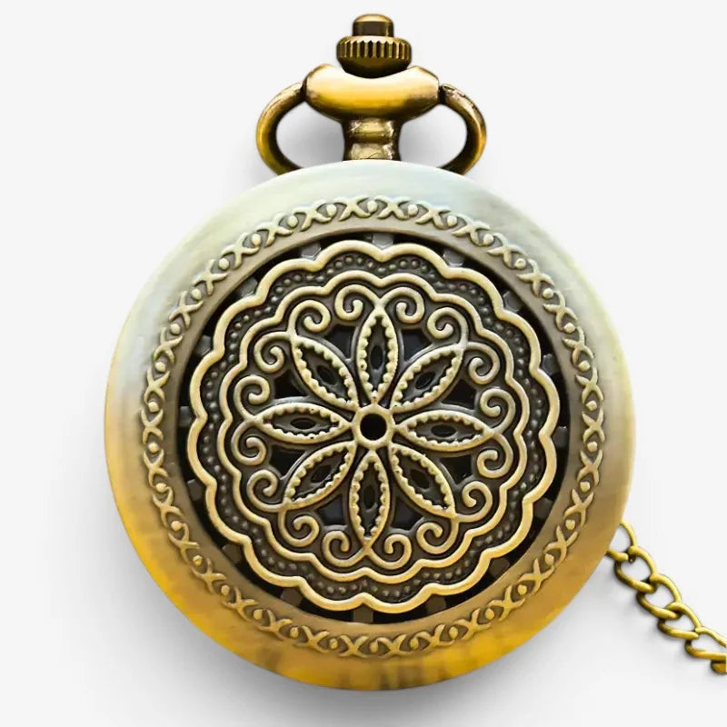 Bronze flower pocket watch with antique brass ornate floral filigree on front cover against pale greenish-white enamel background