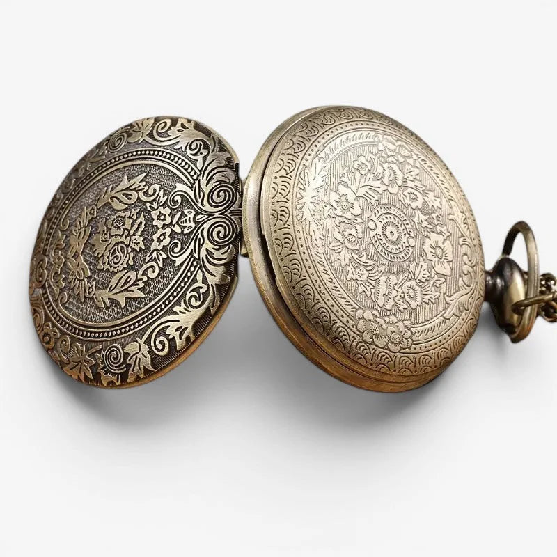 Bronze quartz pocket watch showing antique brass finish with intricate floral and scroll engraving on the back side