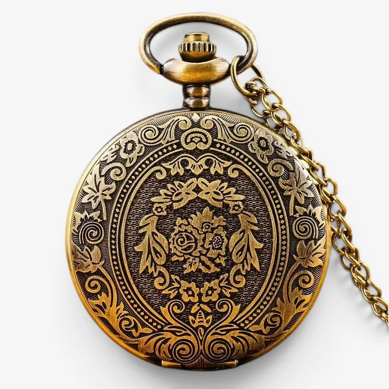 Bronze quartz pocket watch with intricate floral and scrollwork engraving on dark antique brass face attached to chain
