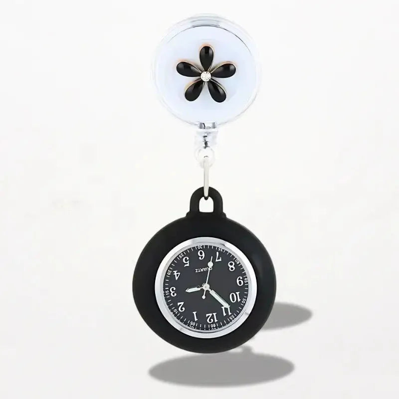Black silicone clip on nurse watch with silver face black numerals and retractable white clip with black flower design