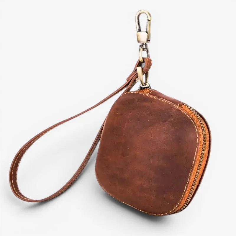 Brown cowhide pocket watch case with brass-toned zipper and metal carabiner clip in leather wristlet style