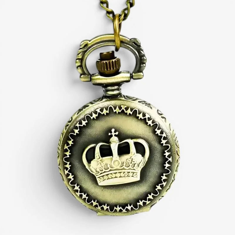 Antique brass-colored crown pocket watch pendant with embossed design and intricate detailing on vintage chain