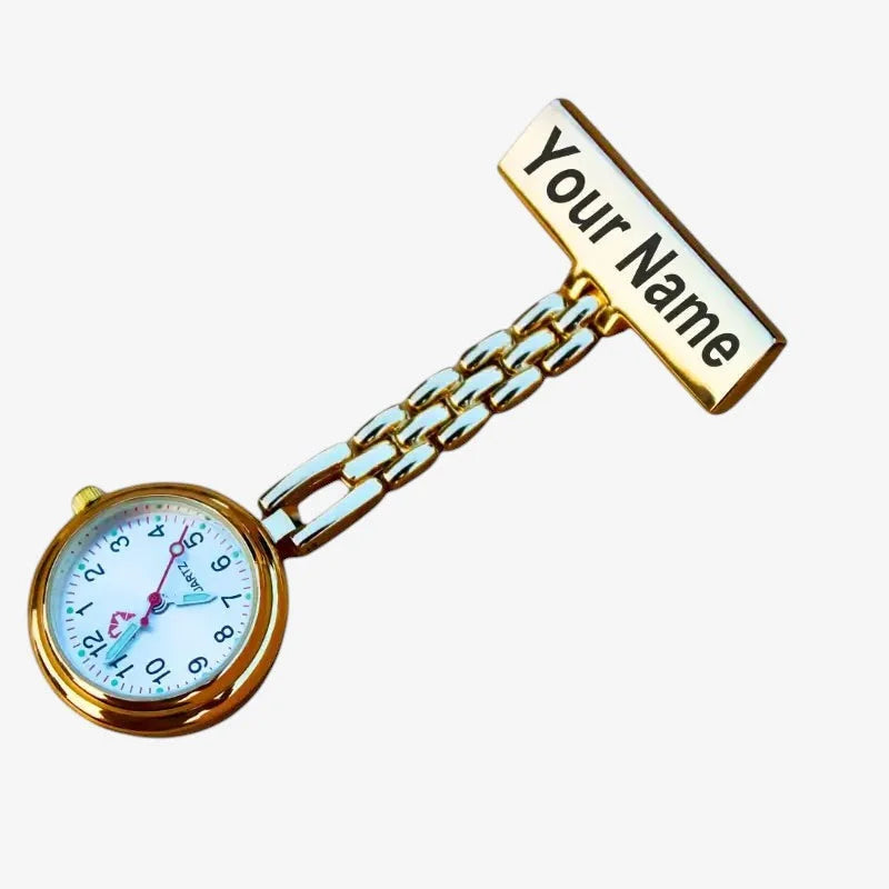 Customizable gold-toned nurse watch with white face black numerals pink hands and engraved nameplate on t-bar