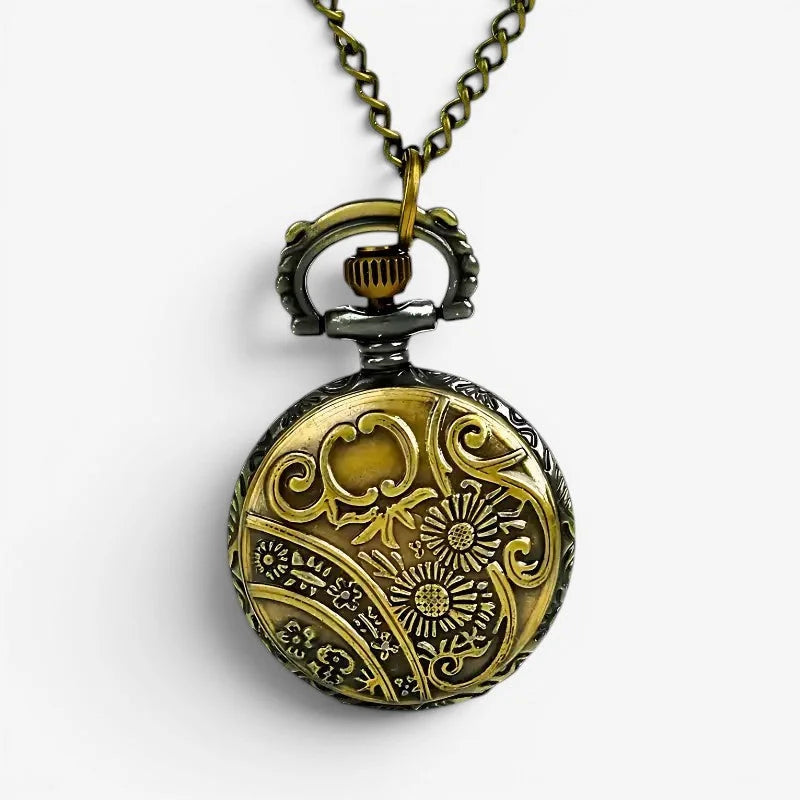 Antique-style brass deer motif pocket watch with intricate floral and scrollwork engraving on a matching chain