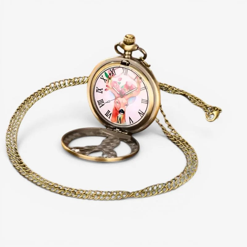 Antique brass deer pocket watch with a pink face illustration attached to an ornate gold chain