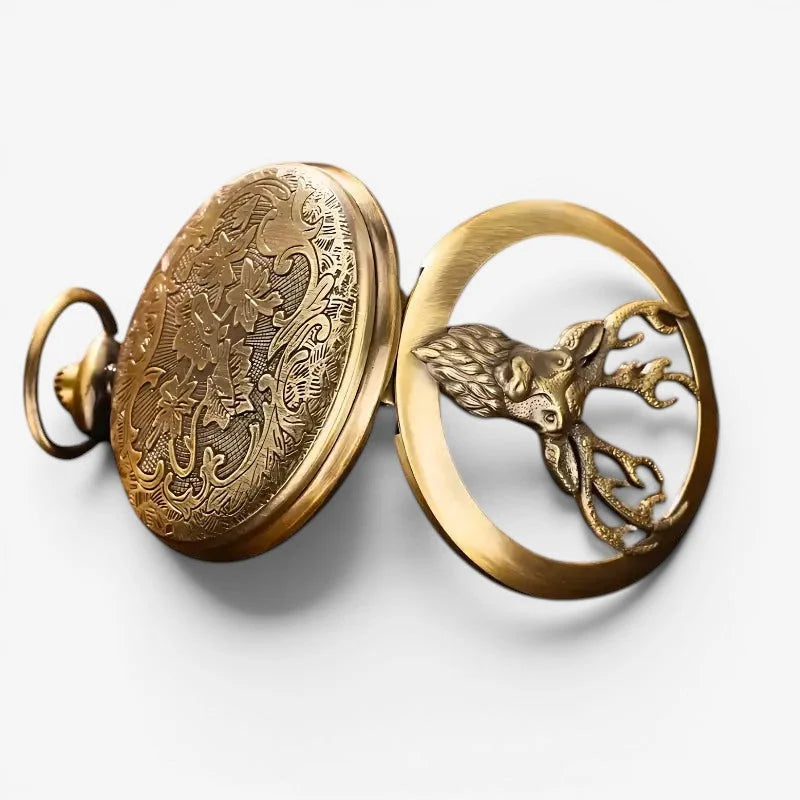 Golden deer pocket watch with intricate floral engraving on the cover and detailed stag head inside the open face