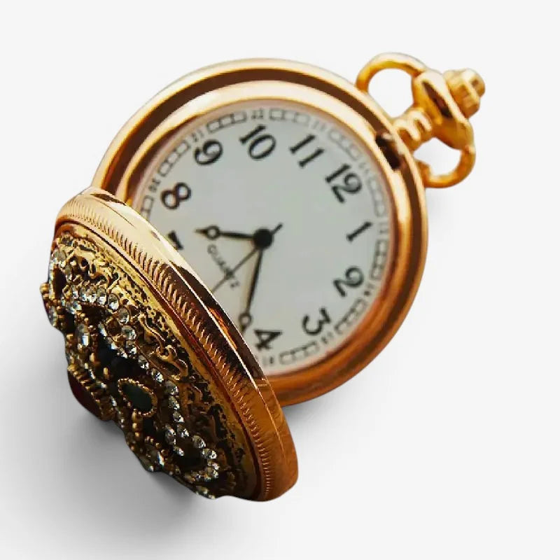 Gold diamond pocket watch with an ornate jeweled cover and white face featuring black arabic numerals