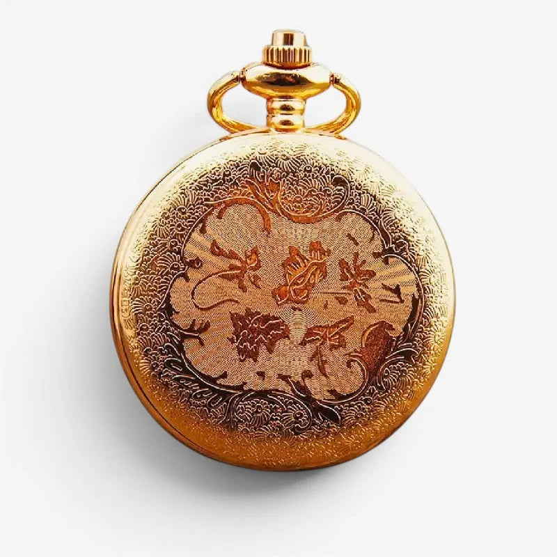 Golden diamond pocket watch with intricate floral and scroll engraving on its face in polished gold finish