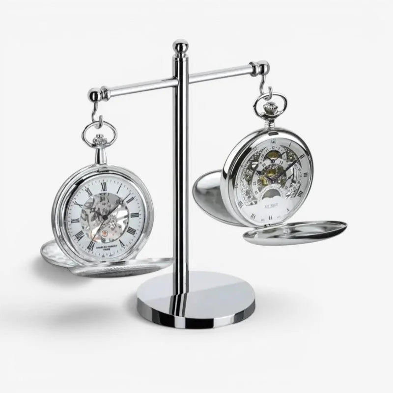 Silver skeleton pocket watches displayed on a chrome dual pocket watch stand for elegant timepiece storage