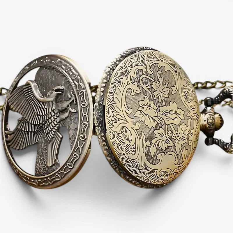 Antique brass eagle pocket watch with intricate engraved bird and floral designs on oval case two halves back view
