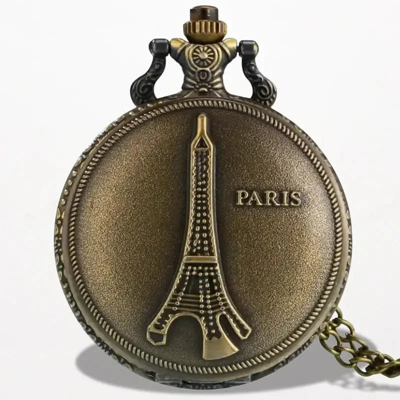 Antique bronze pocket watch with raised Eiffel Tower design and Paris engraving featuring ornate top cap and chain