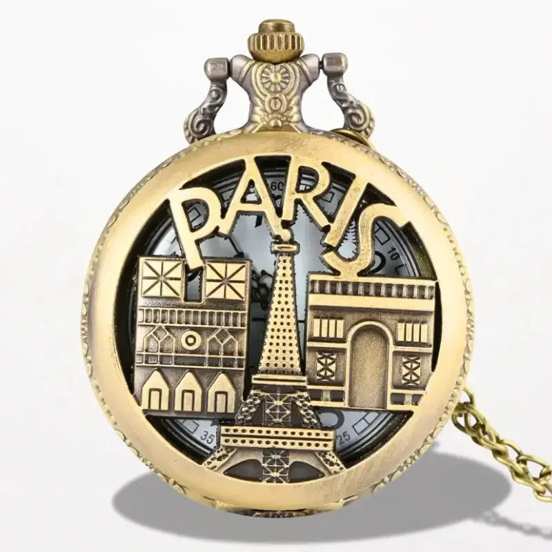 Antique gold-toned eiffel tower pocket watch with intricate parisian landmarks engraved on its face
