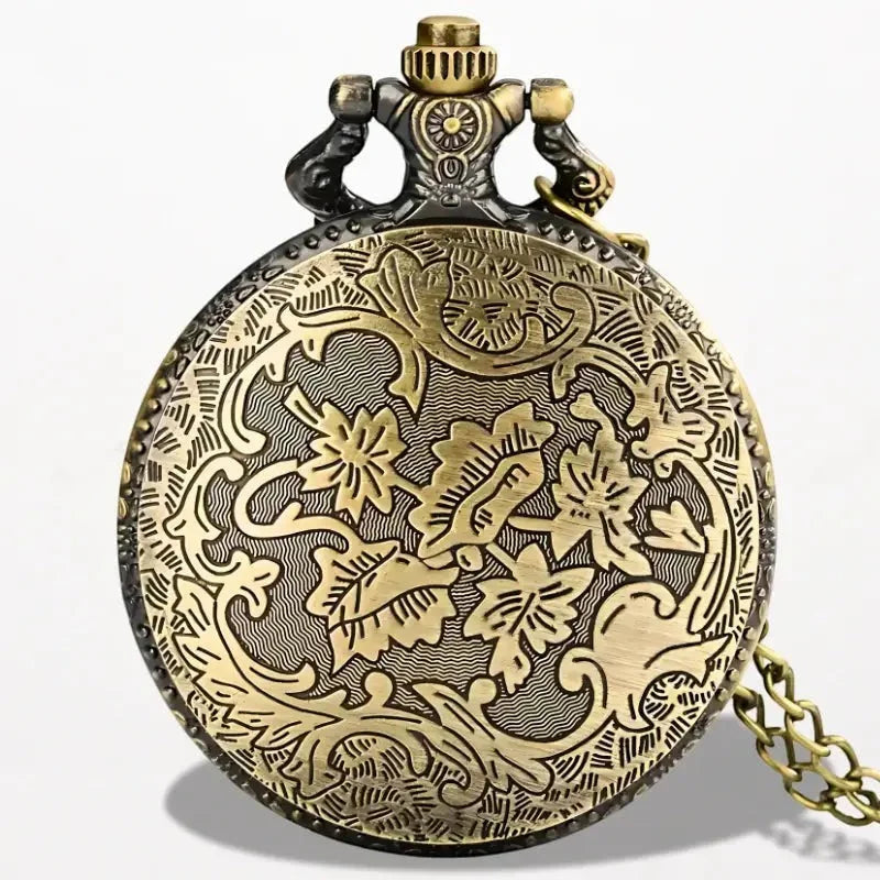 Antique-style brass Eiffel Tower pocket watch with intricate floral engraving blackened top cap and attached chain