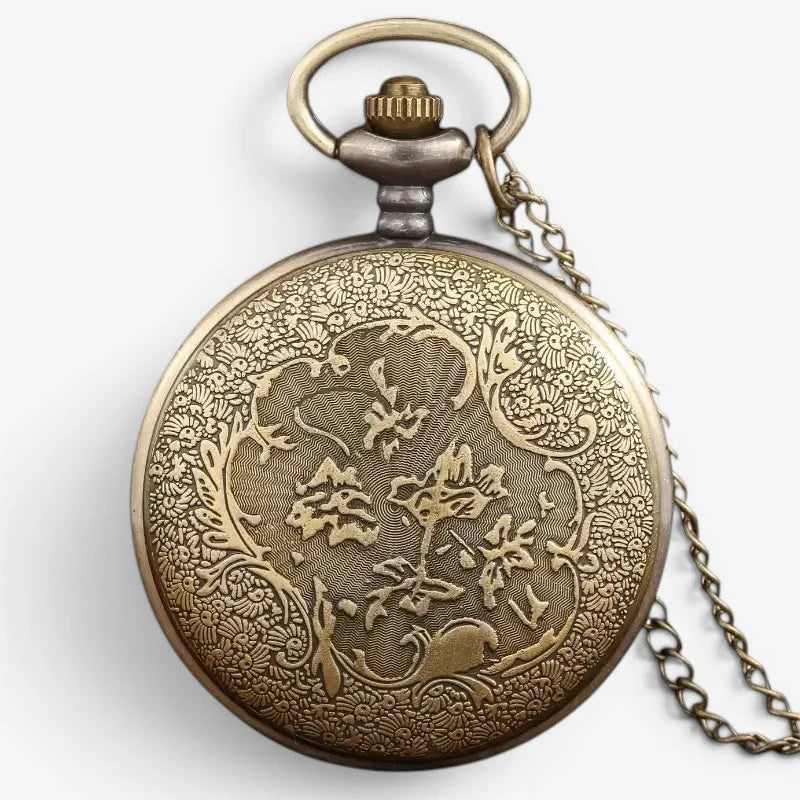 Antique brass elephant pocket watch with intricate floral engravings and matching chain displayed from the back side