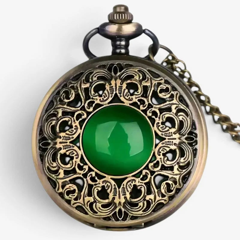 Antique-style emerald pocket watch with ornate brass filigree and a vibrant green jade stone at its center
