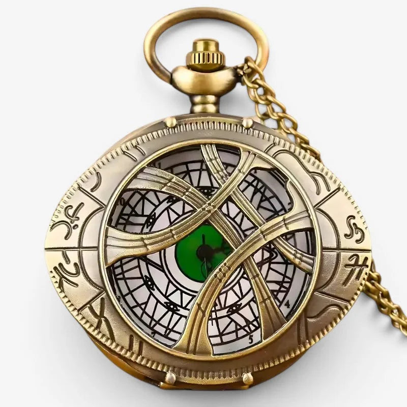 Antique brass eye of agamotto pocket watch with intricate gearwork and a glowing green eye at its center