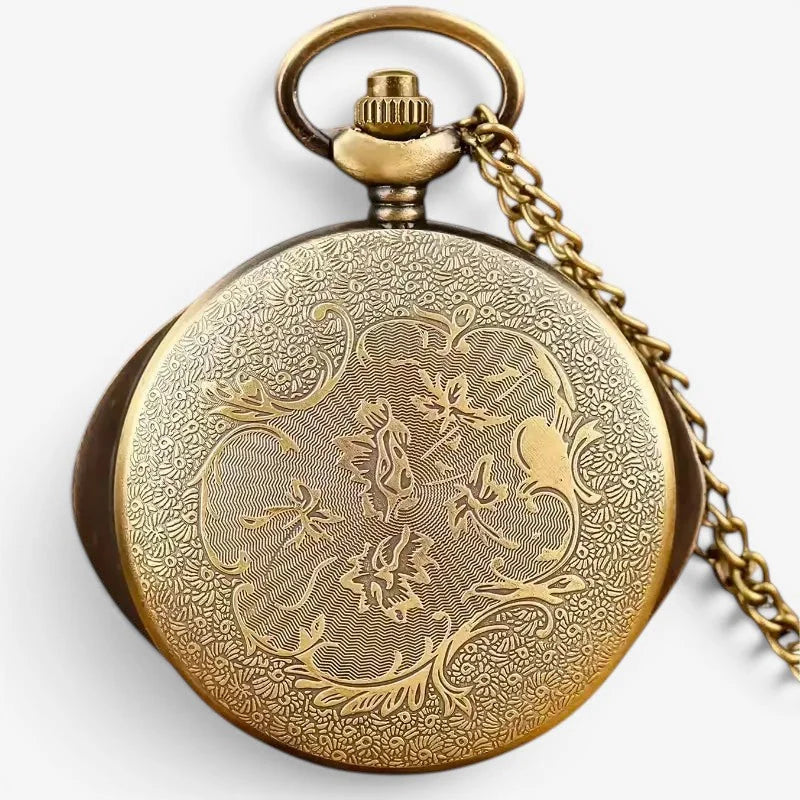 Antique gold-toned Eye of Agamotto pocket watch with intricate floral engraving and matching chain
