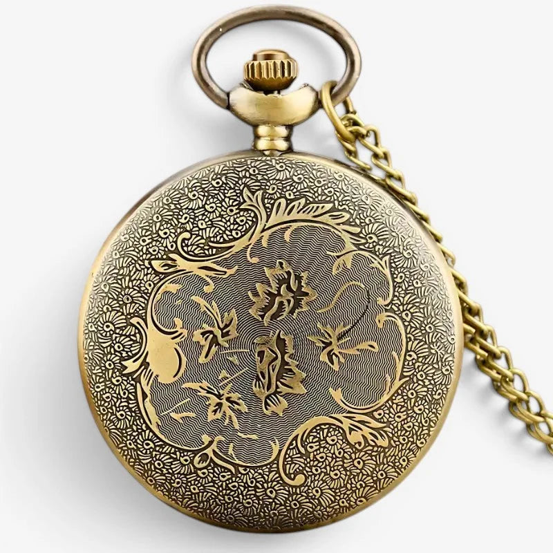 Antique gold-toned eye of providence pocket watch with intricate floral vine engraving and matching chain